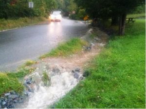 stormwater overflowing and flooding a street