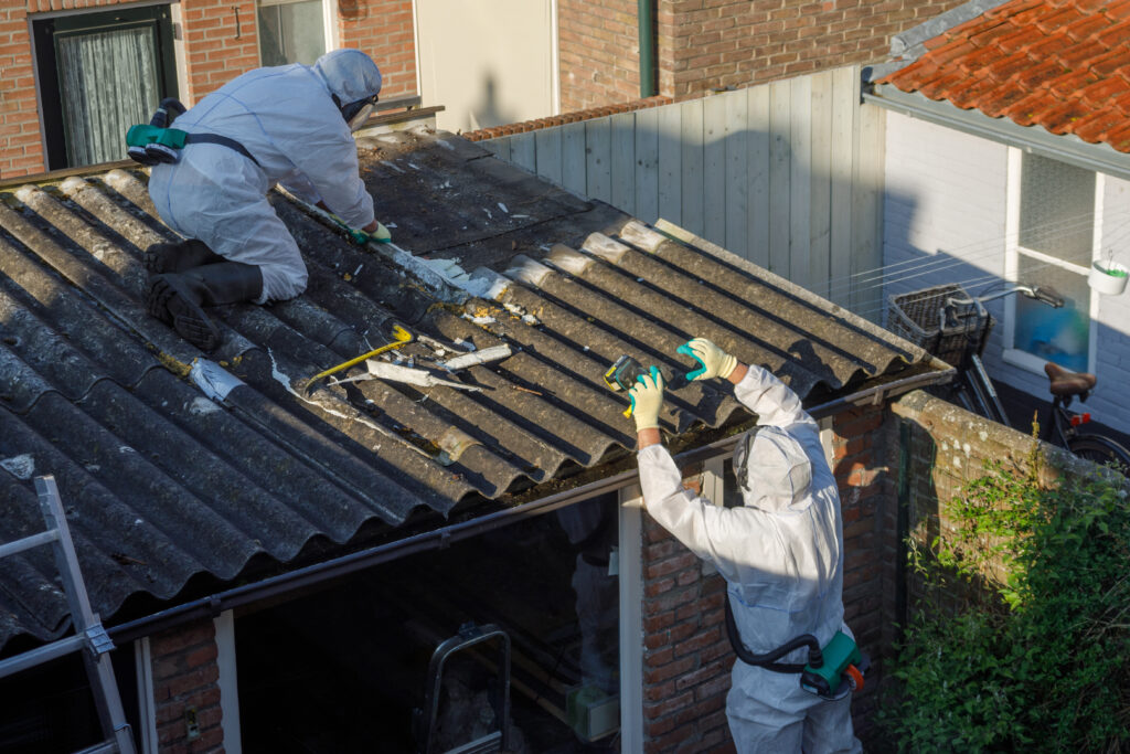 two people in hazmat suits removing a roof