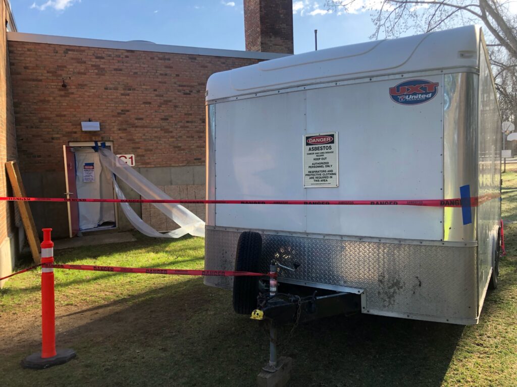 tariler with an asbetos danger notice